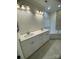 A bathroom has a tiled accent wall above a soaking tub and a double sink vanity at 17408 Summer Place Dr, Cornelius, NC 28031