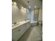 A bathroom has a tiled accent wall above a soaking tub and a double sink vanity at 17408 Summer Place Dr, Cornelius, NC 28031