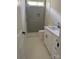 This bathroom is equipped with a shower, white tiled floors, and a white vanity at 17408 Summer Place Dr, Cornelius, NC 28031