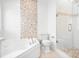 Elegant bathroom with soaking tub, glass shower, and stylish accent tile at 17408 Summer Place Dr, Cornelius, NC 28031