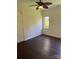 Bright bedroom features hardwood floors, neutral walls, ceiling fan, and natural light at 17408 Summer Place Dr, Cornelius, NC 28031