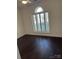 A cozy bedroom has a hardwood floor and a window with bright natural light at 17408 Summer Place Dr, Cornelius, NC 28031