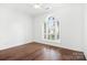 Bright bedroom boasts hardwood floors, neutral paint, and plantation shutters at 17408 Summer Place Dr, Cornelius, NC 28031