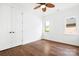 Bright bedroom features hardwood floors, neutral paint, and a ceiling fan at 17408 Summer Place Dr, Cornelius, NC 28031