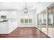 Bright dining area with white cabinets, modern lighting, and access to a patio at 17408 Summer Place Dr, Cornelius, NC 28031