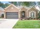 Charming single-story brick home featuring a two-car garage and well-maintained landscaping at 17408 Summer Place Dr, Cornelius, NC 28031