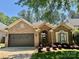 Charming brick home with a well-manicured lawn and inviting two-car garage, under a sunny blue sky at 17408 Summer Place Dr, Cornelius, NC 28031