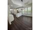 A spacious kitchen boasts dark hardwood floors, a kitchen island, and stainless steel appliances at 17408 Summer Place Dr, Cornelius, NC 28031