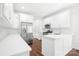 Modern kitchen with stainless steel appliances, white cabinets, and quartz countertops at 17408 Summer Place Dr, Cornelius, NC 28031