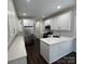 Modern kitchen with white cabinets, quartz countertops, and stainless steel appliances at 17408 Summer Place Dr, Cornelius, NC 28031