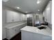 Bright kitchen boasts white cabinetry, modern appliances, and quartz countertops at 17408 Summer Place Dr, Cornelius, NC 28031