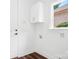 Bright laundry room features modern cabinetry and wood-look flooring at 17408 Summer Place Dr, Cornelius, NC 28031