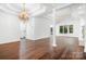 Spacious living room with hardwood floors, elegant chandelier, and bright natural light at 17408 Summer Place Dr, Cornelius, NC 28031