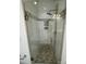 A glass shower has tiled walls with an accent strip and a pebble tiled floor at 17408 Summer Place Dr, Cornelius, NC 28031
