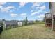 Large, grassy backyard enclosed by a black metal fence, offering ample space and a serene outdoor environment at 17502 Snug Harbor Rd, Charlotte, NC 28278