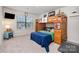 Bright bedroom with unique bunk bed design and playful dinosaur decorations, providing a cozy and fun space at 17502 Snug Harbor Rd, Charlotte, NC 28278