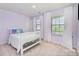 Bright, purple bedroom with white furniture, and large windows at 17502 Snug Harbor Rd, Charlotte, NC 28278