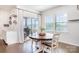 Cozy dining area with a round wooden table, access to the screened-in porch, and ample natural light at 17502 Snug Harbor Rd, Charlotte, NC 28278