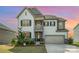Charming two-story home with white siding, a two-car garage, and manicured landscaping at 17502 Snug Harbor Rd, Charlotte, NC 28278