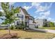 Charming two-story home with a combination of white siding, a two-car garage and landscaping at 17502 Snug Harbor Rd, Charlotte, NC 28278