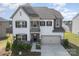 Two-story home with a combination of white siding, a two-car garage and manicured landscaping at 17502 Snug Harbor Rd, Charlotte, NC 28278