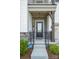 A covered front porch with stone accents and iron railings welcomes you to the entrance at 17502 Snug Harbor Rd, Charlotte, NC 28278