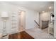 Bright hallway features neutral carpet, wood trim staircase, and a white decorative ladder at 17502 Snug Harbor Rd, Charlotte, NC 28278