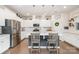 Well-lit kitchen features white cabinets, a center island with bar stools, stainless steel appliances, and hardwood floors at 17502 Snug Harbor Rd, Charlotte, NC 28278