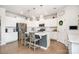Modern kitchen with stainless steel appliances, white cabinets, a center island and pendant lighting above at 17502 Snug Harbor Rd, Charlotte, NC 28278