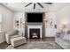 Cozy living room with fireplace, built-in shelves, and ceiling fan at 17502 Snug Harbor Rd, Charlotte, NC 28278