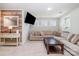 Spacious living room features a large sectional sofa, mounted tv, and wood accent wall at 17502 Snug Harbor Rd, Charlotte, NC 28278