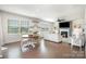 Open-concept living room and dining area with hardwood floors, natural light, and a fireplace at 17502 Snug Harbor Rd, Charlotte, NC 28278