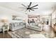 Bright living room features stylish couches, a ceiling fan, and a seamless transition to the kitchen and dining area at 17502 Snug Harbor Rd, Charlotte, NC 28278