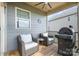 Inviting covered patio with comfortable wicker seating, a ceiling fan, and a grill, perfect for outdoor relaxation at 17502 Snug Harbor Rd, Charlotte, NC 28278