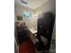 Compact bathroom with essential amenities, storage shelving, and a combination shower and tub setup at 1849 Brownstone St, Charlotte, NC 28216