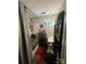 A compact bathroom featuring a combination shower and tub, plus shelving for extra storage at 1849 Brownstone St, Charlotte, NC 28216