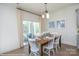 Bright dining area with hardwood floors, a wooden table with seating, and sliding glass door access to the backyard at 2007 Mantle Ridge Dr # 192, Indian Trail, NC 28079