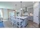 Open-concept kitchen with stainless steel appliances, gray cabinets, an island, and pendant lighting at 2007 Mantle Ridge Dr # 192, Indian Trail, NC 28079