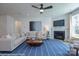 Comfortable living room features a fireplace, plush seating, a ceiling fan, and natural light from large windows at 2007 Mantle Ridge Dr # 192, Indian Trail, NC 28079