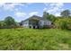 Spacious backyard with lush green grass and a charming home featuring a screened porch, great for outdoor enjoyment at 209 Sheffield Dr, York, SC 29745