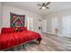 Spacious bedroom with ceiling fan and wood-look flooring, with multiple doors leading to other rooms at 209 Sheffield Dr, York, SC 29745