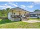 Quaint home with a welcoming porch and staircase leading to the entrance, nestled in a serene and green neighborhood at 209 Sheffield Dr, York, SC 29745