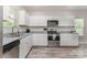Beautiful kitchen boasts stainless steel appliances and white cabinets with a window view at 209 Sheffield Dr, York, SC 29745
