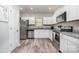 Bright kitchen features stainless appliances, granite countertops, and wood-look flooring at 209 Sheffield Dr, York, SC 29745
