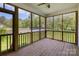 Inviting screened porch with wood floors and a beautiful backyard view, perfect for relaxing and enjoying the outdoors at 209 Sheffield Dr, York, SC 29745