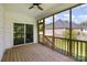 Relaxing screened-in porch with wood flooring, offering a peaceful view of the backyard and neighboring home at 209 Sheffield Dr, York, SC 29745