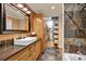 Bathroom with a modern sink, wooden cabinets, walk-in closet and a shower at 218 N Bost St, Statesville, NC 28677