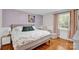 Calming main bedroom with hardwood floors and natural light at 218 N Bost St, Statesville, NC 28677