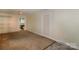 Spacious bedroom with neutral walls, carpet, and access to a bathroom, creating a comfortable and private retreat at 218 N Bost St, Statesville, NC 28677