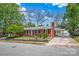 Charming brick home with well-manicured lawn, red front door, and covered carport at 218 N Bost St, Statesville, NC 28677
